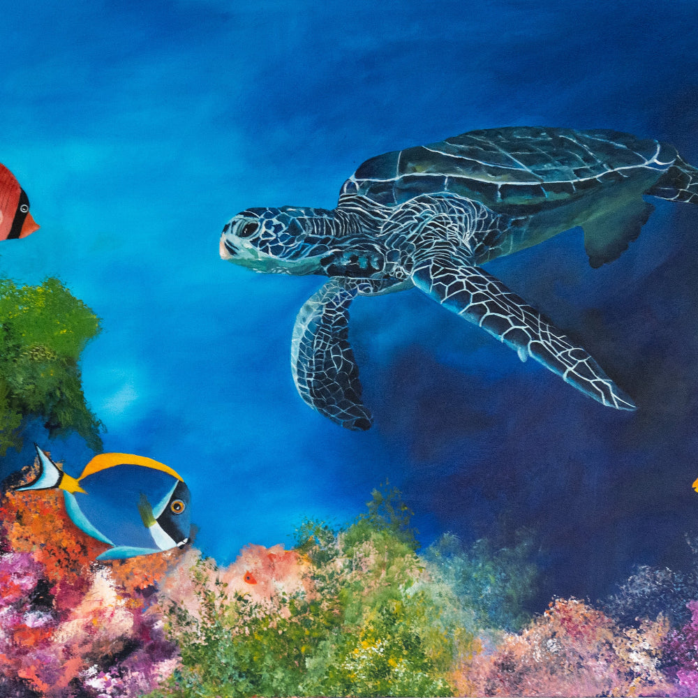 Tortoise swimming in a vibrant underwater scene with colorful fish and coral.